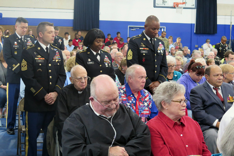 Anne Marie Amacher Members of the U.S. Army currently serving at the Rock Island, Ill., Arsenal stand during a Veterans Day ceremony at All Saints Catholic School in Davenport. Active duty military personnel and veterans from all branches of service were invited to the annual event. 