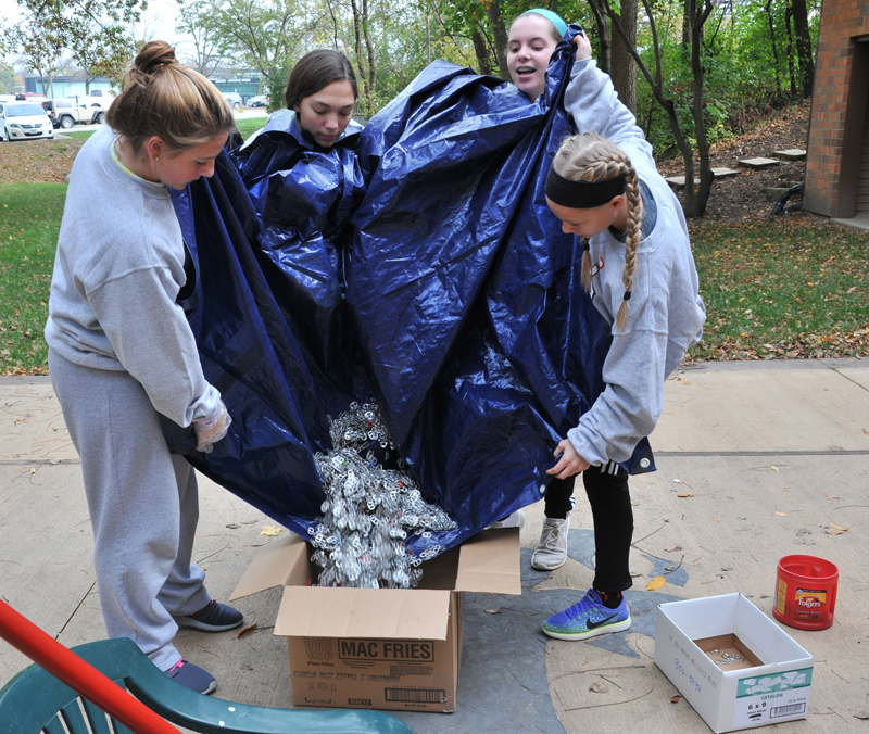 Lindsay Steele Regina Catholic Education Center eighth-graders sort through pop tabs at the Ronald McDonald House in Iowa City Oct. 28. Pictured are, from left,  Baylee O’Connor, Abby Clark, Olivia Clark and Natalie Green. 