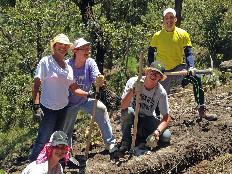 Jane Shey Tyla Cole, standing at left, takes a break with other missionaries from digging trenches in Honduras earlier this fall. 