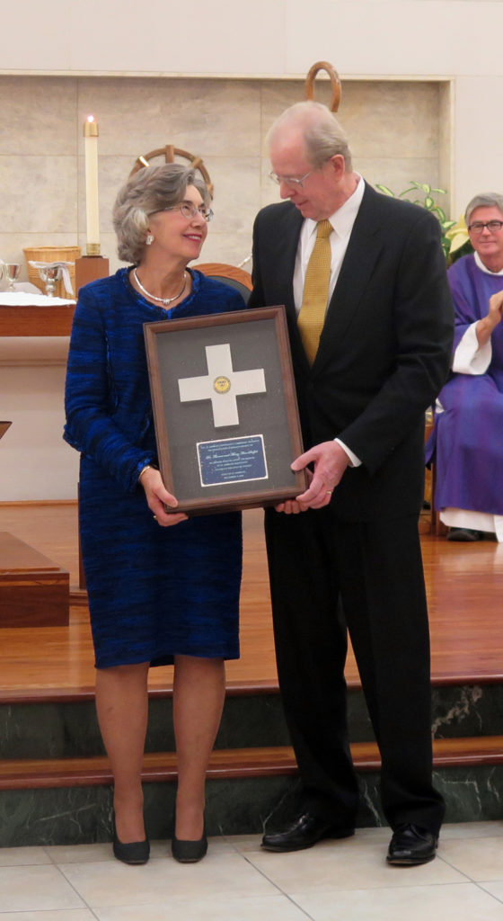 Anne Marie Amacher Tom and Mary Ann Stoffel celebrate their McMullen Award Dec. 4 in Christ the King Chapel at St. Ambrose University in Davenport.