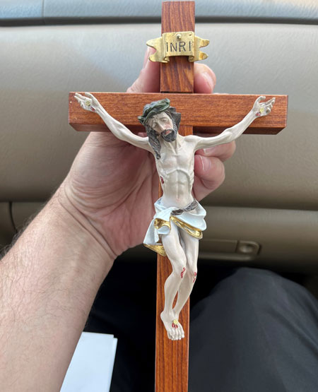 Priest makes crucifixes from old church pews