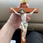 Priest makes crucifixes from old church pews